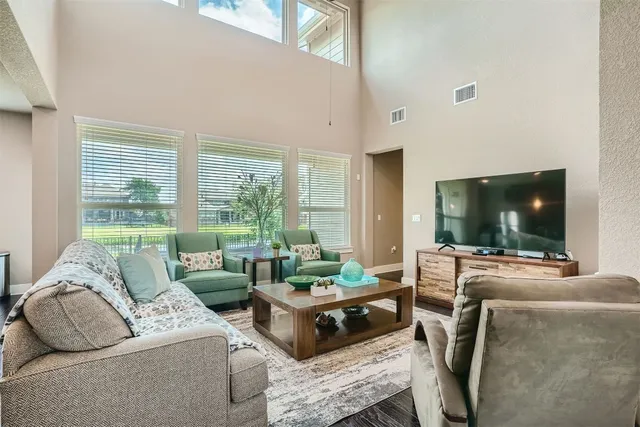 a living room with furniture and a large window
