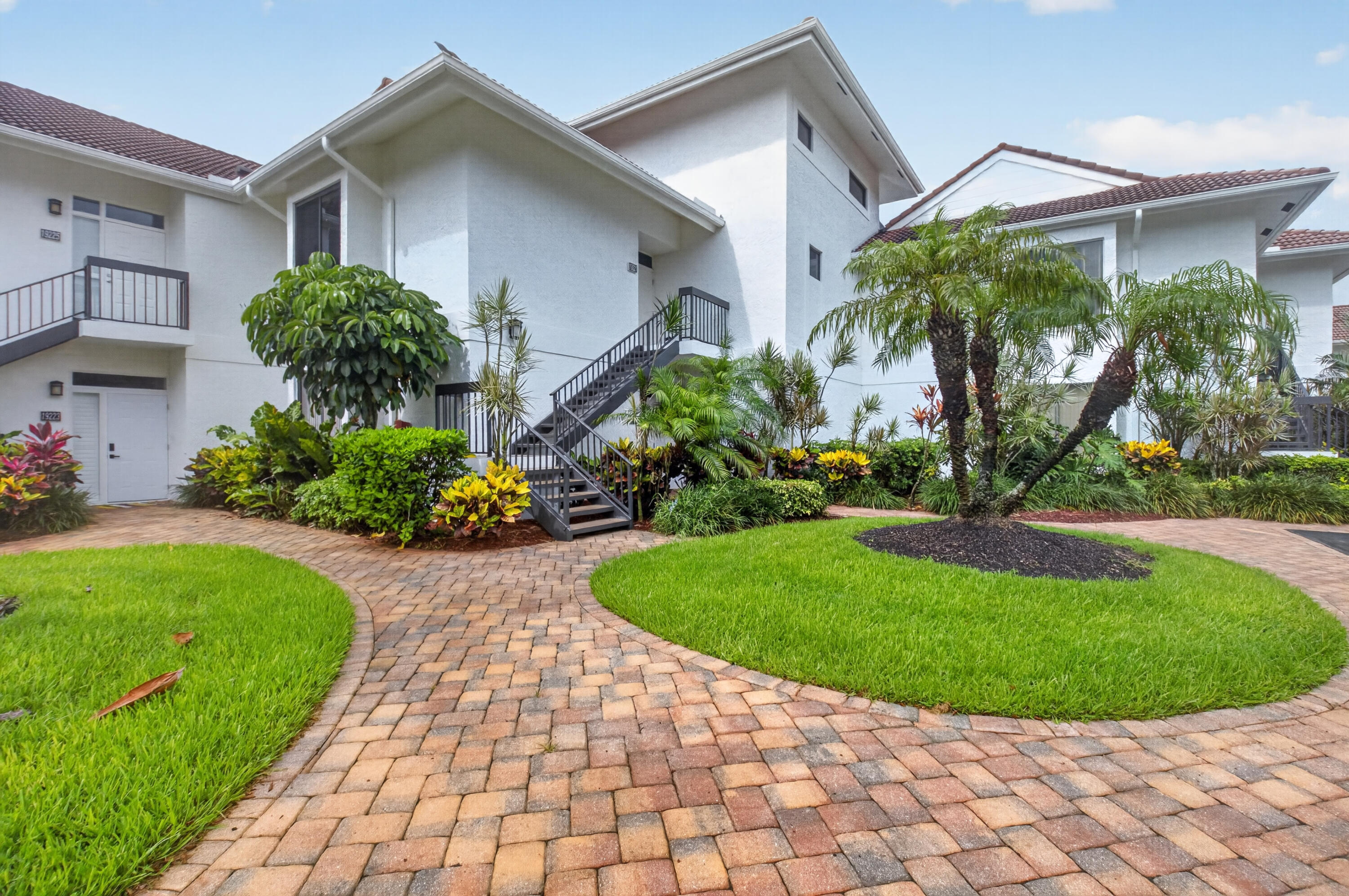 19221 Sabal Lake Drive, Unit 5124 Boca Raton, FL 33434 - Photo 3 of 98 a front view of a house with a yard