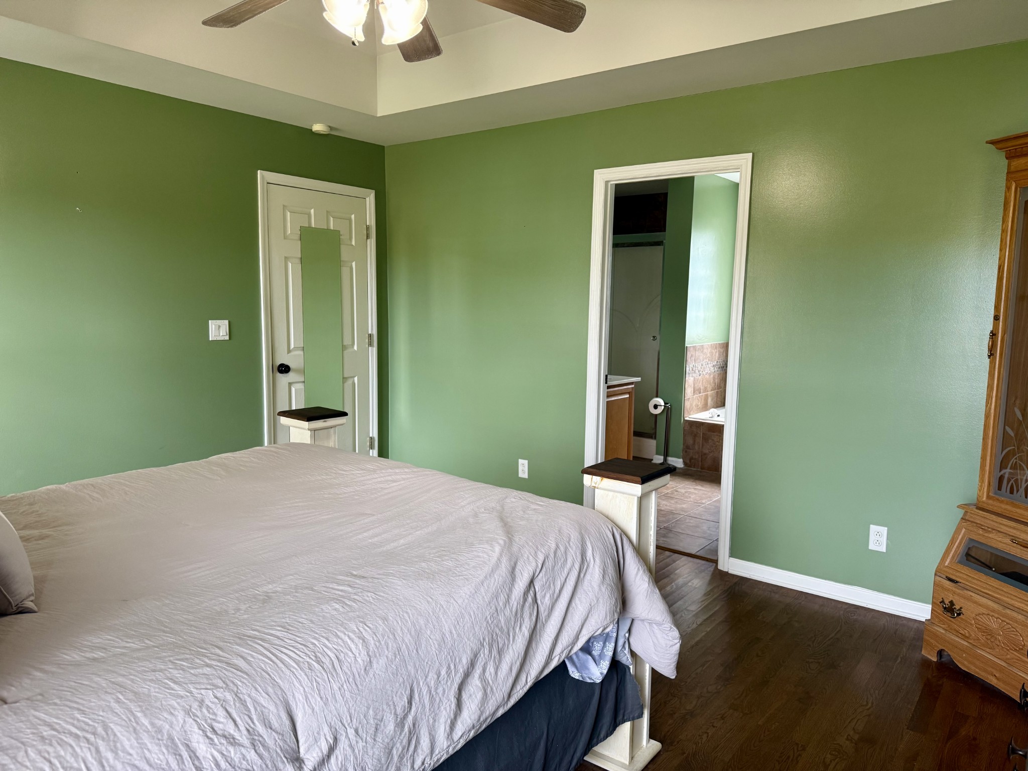 125 Maple Ridge Court McMinnville, TN 37110 - Photo 20 of 44 a bedroom with a bed and a chandelier