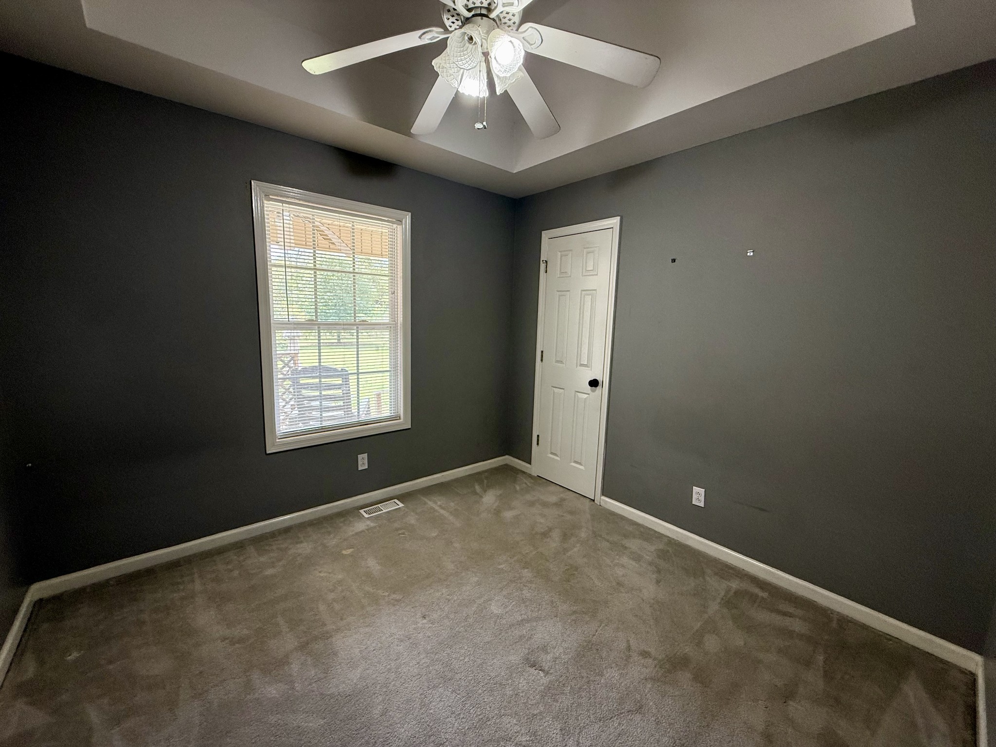125 Maple Ridge Court McMinnville, TN 37110 - Photo 25 of 44 an empty room with a chandelier fan and windows