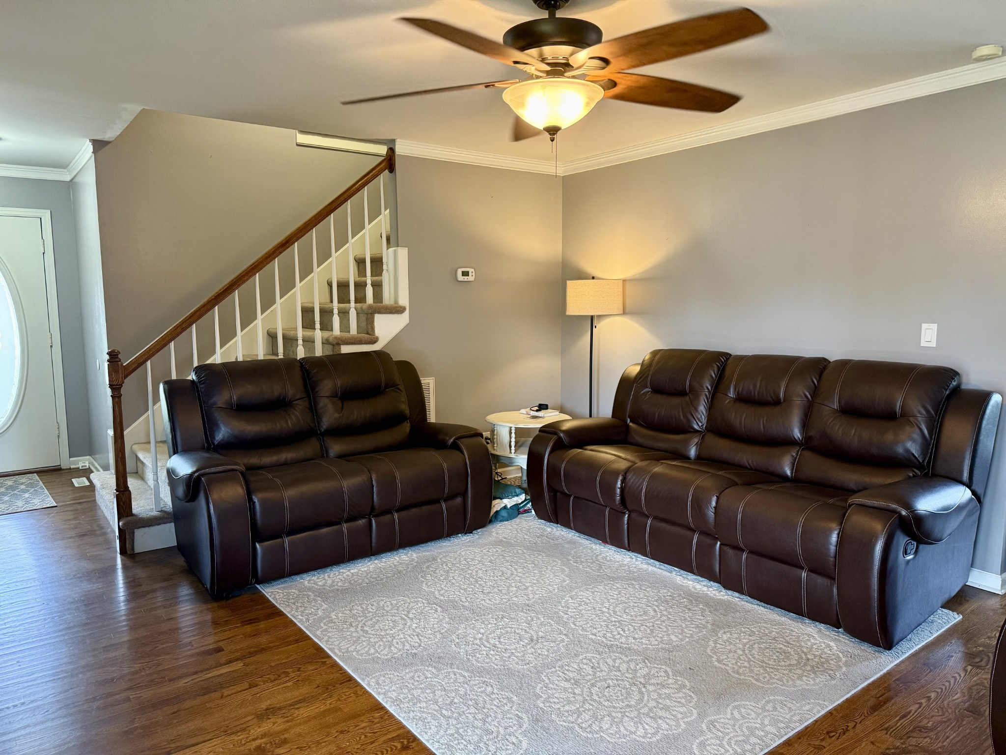 125 Maple Ridge Court McMinnville, TN 37110 - Photo 7 of 44 a living room with couches and a ceiling fan with wooden floor