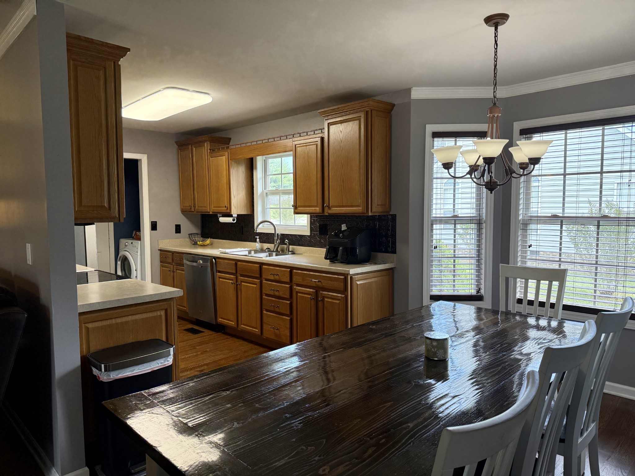 125 Maple Ridge Court McMinnville, TN 37110 - Photo 9 of 44 a kitchen with sink refrigerator dining table and chairs