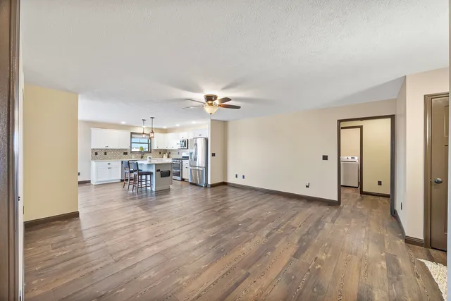 a view of a livingroom and dining room with wooden floor