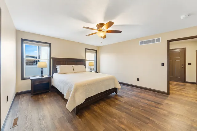 a bedroom with a bed and a chandelier