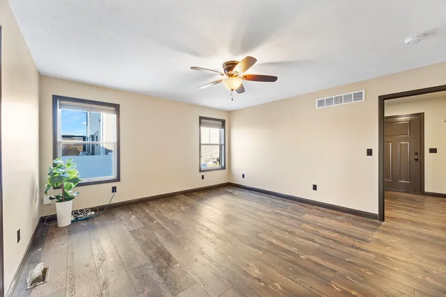 wooden floor in an empty room with a window
