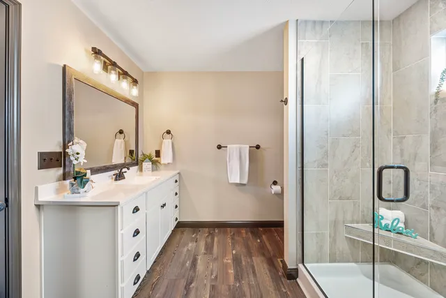 a bathroom with a double vanity sink and mirror