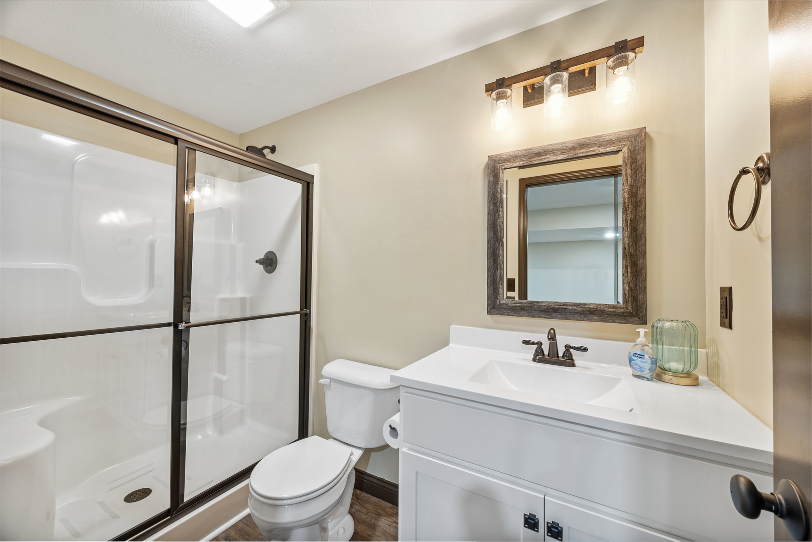 2172 Granby Lane Normal, IL 61761 - Photo 35 of 39 a bathroom with a sink a mirror a toilet and shower