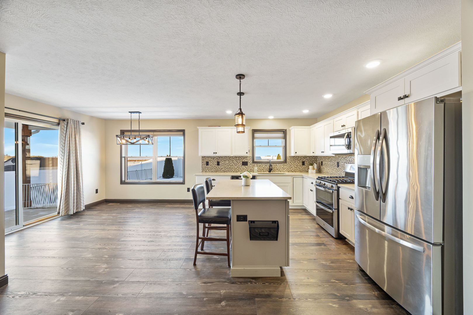 2172 Granby Lane Normal, IL 61761 - Photo 9 of 39 a kitchen with stainless steel appliances kitchen island granite countertop a refrigerator a stove oven and white cabinets with wooden floor