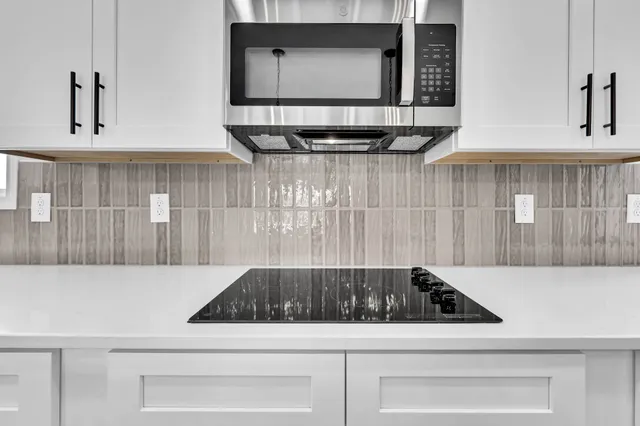 a kitchen with a stove and a microwave