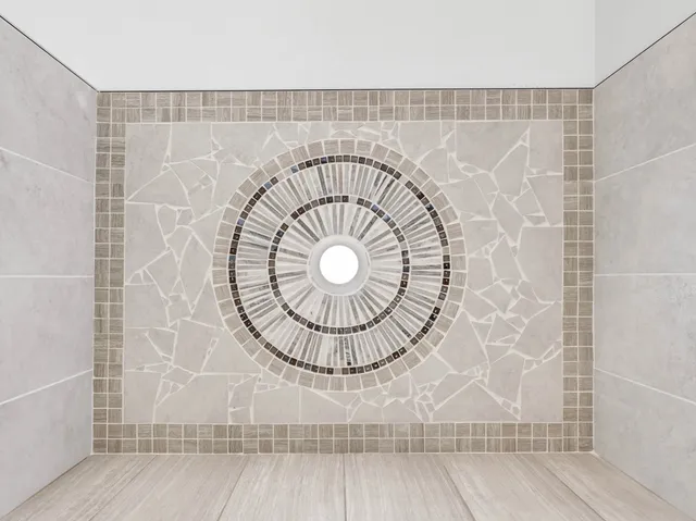 a bathroom with a glass shower door and a glass door