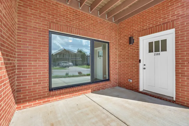 a view of a brick house with a large window