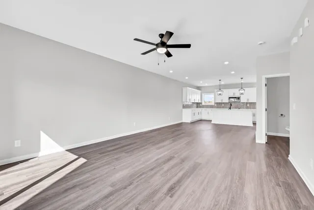 a view of a kitchen with wooden floor and a kitchen