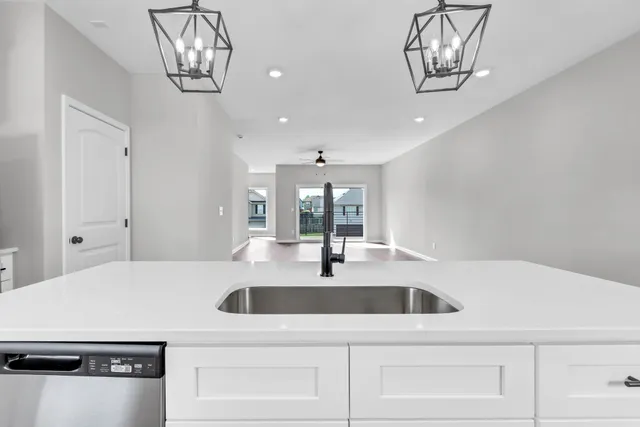 a kitchen with a sink and chandelier