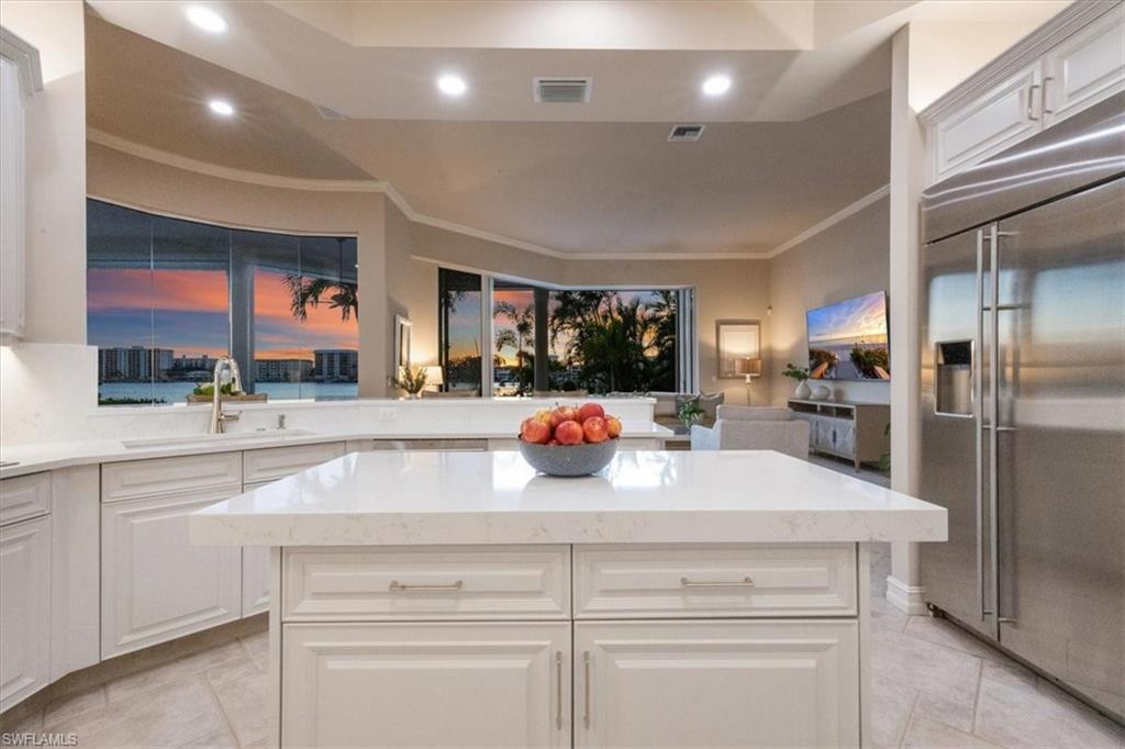 2825 Leeward Lane Naples, FL 34103 - Photo 11 of 44 a kitchen with stainless steel appliances a sink and a refrigerator
