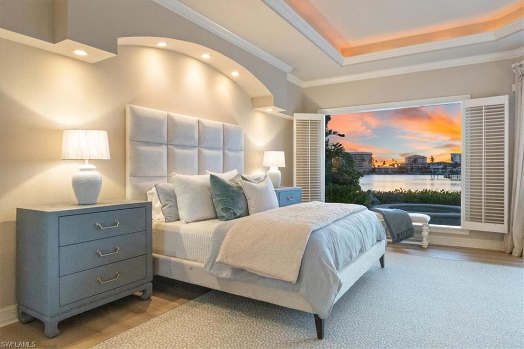 2825 Leeward Lane Naples, FL 34103 - Photo 14 of 44 a bedroom with a bed and window