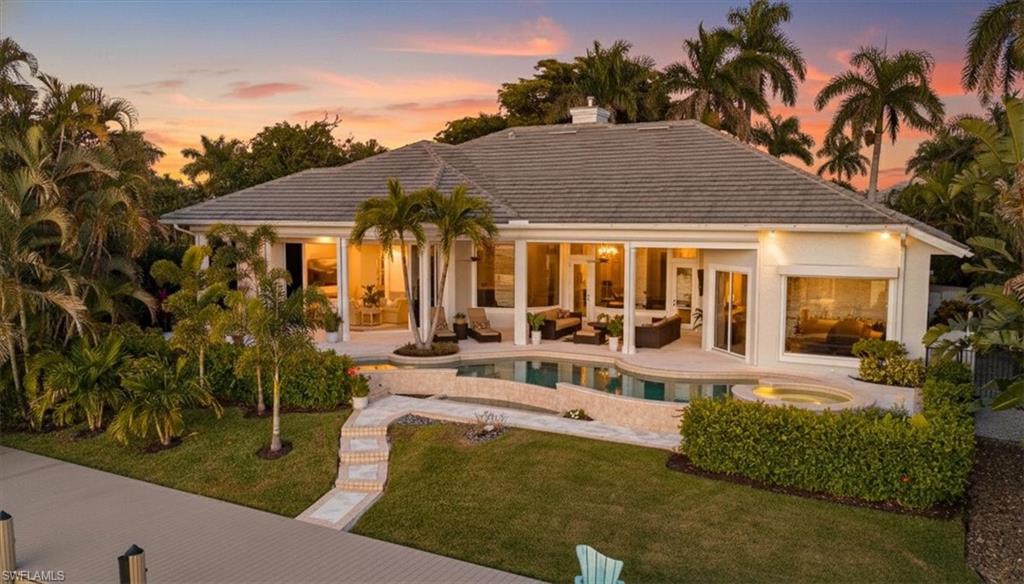 2825 Leeward Lane Naples, FL 34103 - Photo 36 of 44 a view of a house with backyard and sitting area