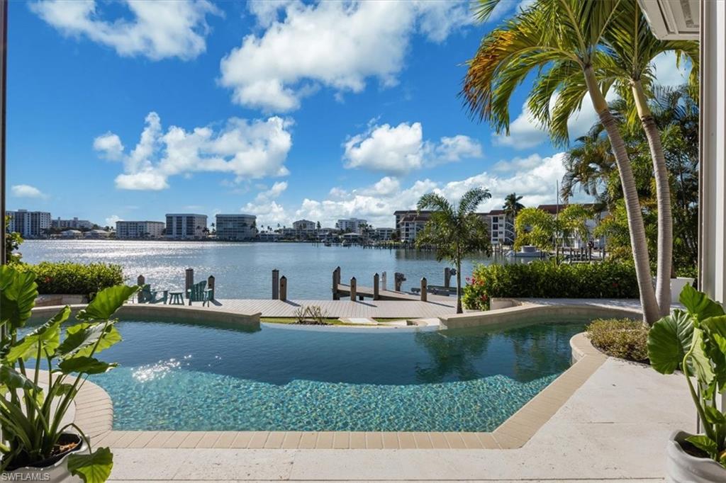 2825 Leeward Lane Naples, FL 34103 - Photo 38 of 44 a view of a lake with houses