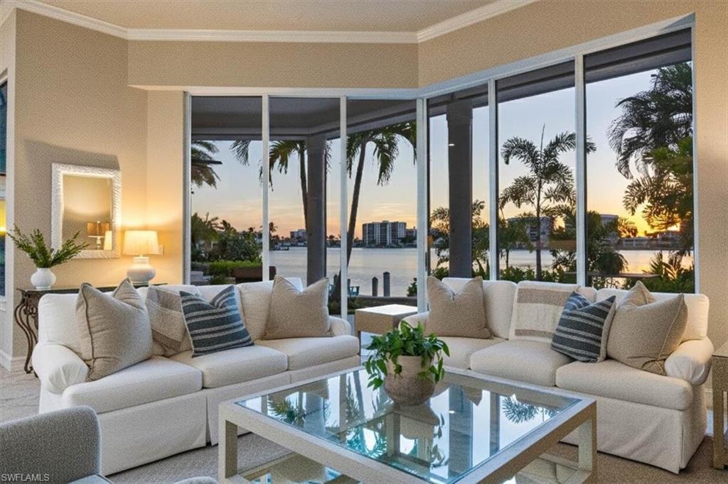 2825 Leeward Lane Naples, FL 34103 - Photo 8 of 44 a living room with furniture and a large window