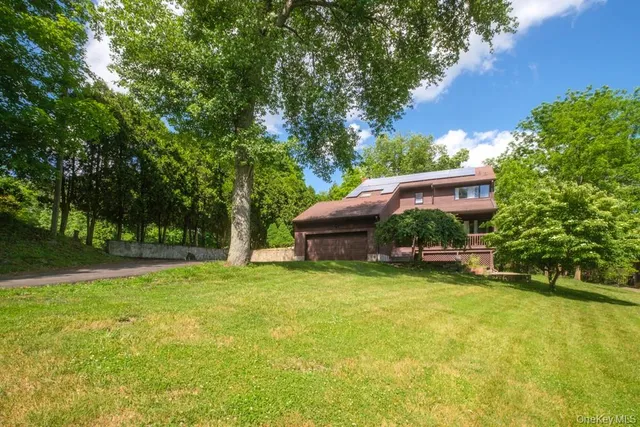 an aerial view of a house with a yard swimming pool and outdoor seating