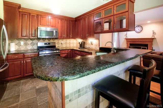 a kitchen with a stove a sink and a microwave