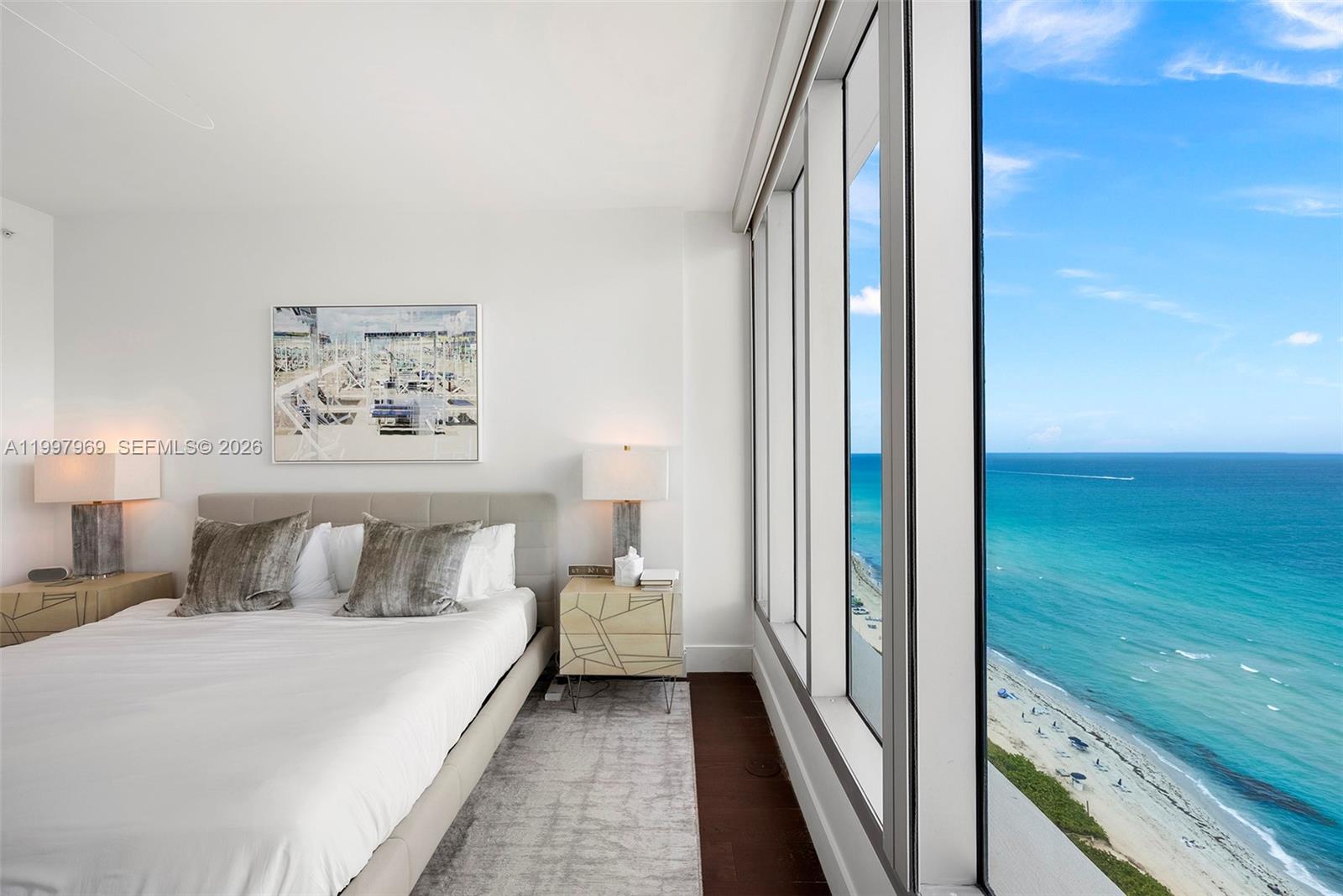6899 Collins Avenue, Unit 1908 Miami Beach, FL 33141 - Photo 13 of 63 a bedroom with a bed and a view of balcony
