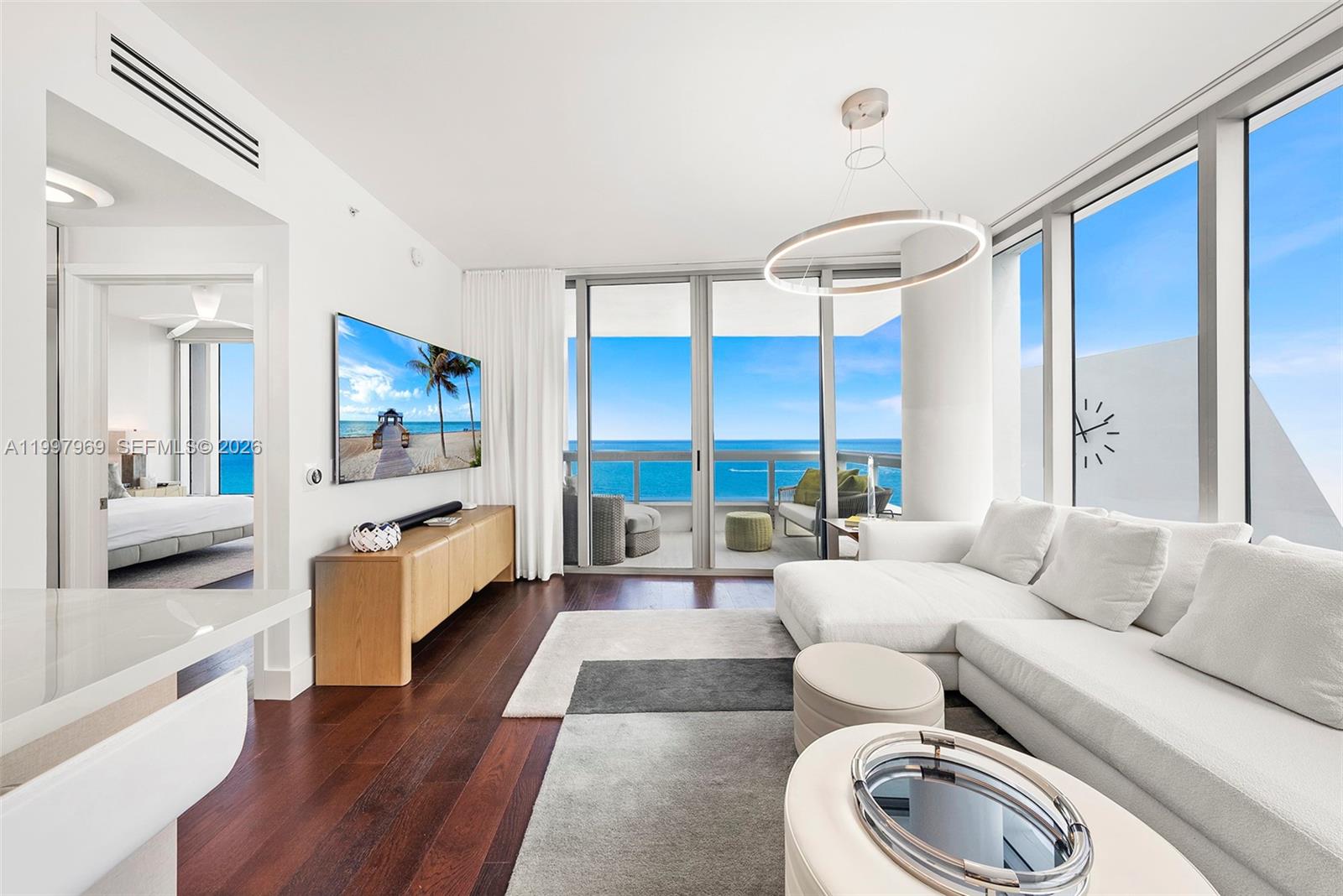 6899 Collins Avenue, Unit 1908 Miami Beach, FL 33141 - Photo 17 of 63 a living room with furniture and a large window