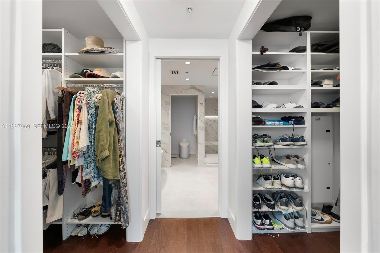 6899 Collins Avenue, Unit 1908 Miami Beach, FL 33141 - Photo 24 of 63 a view of walk in closet with clothes and shoes