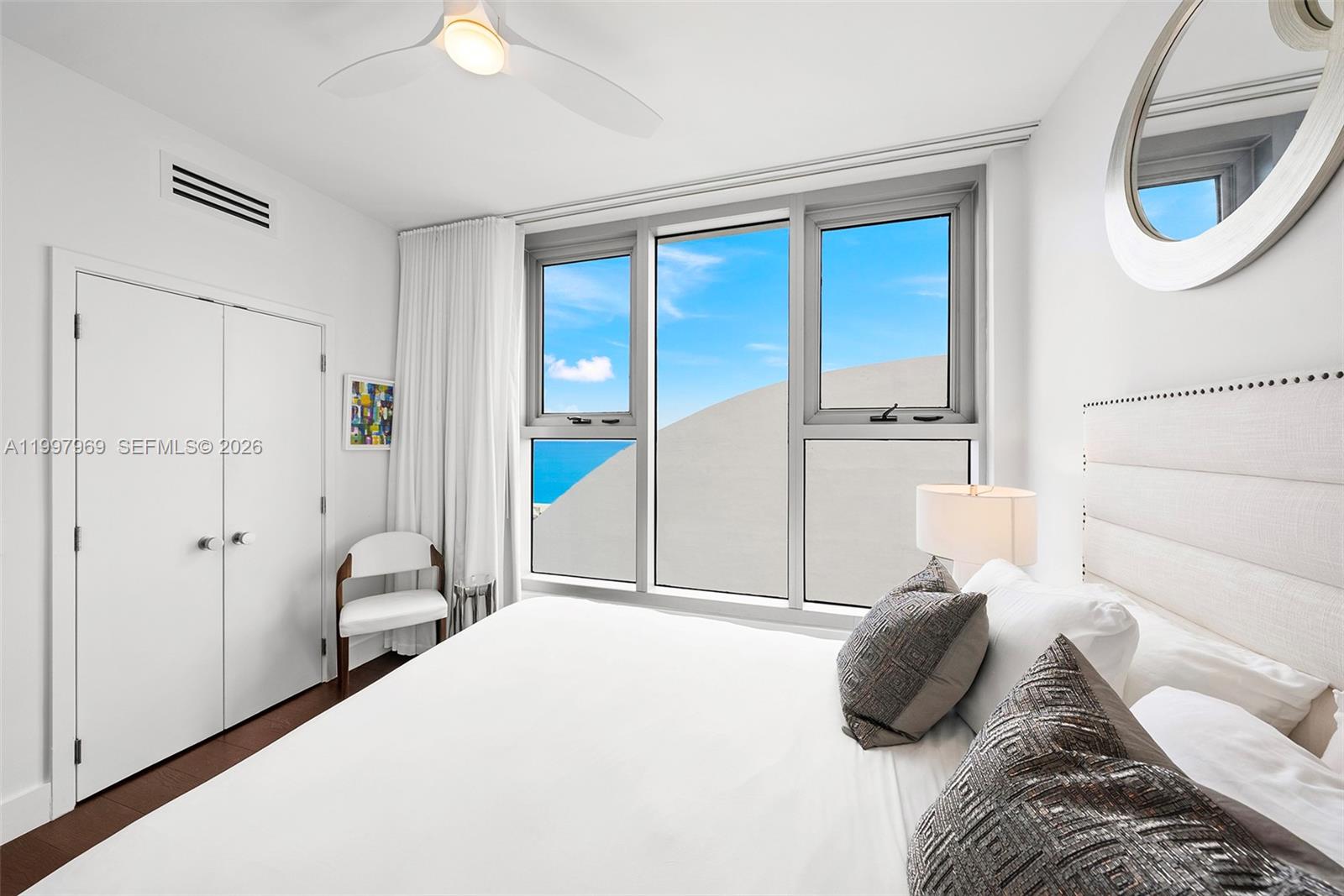 6899 Collins Avenue, Unit 1908 Miami Beach, FL 33141 - Photo 27 of 63 a bedroom with a bed and a window