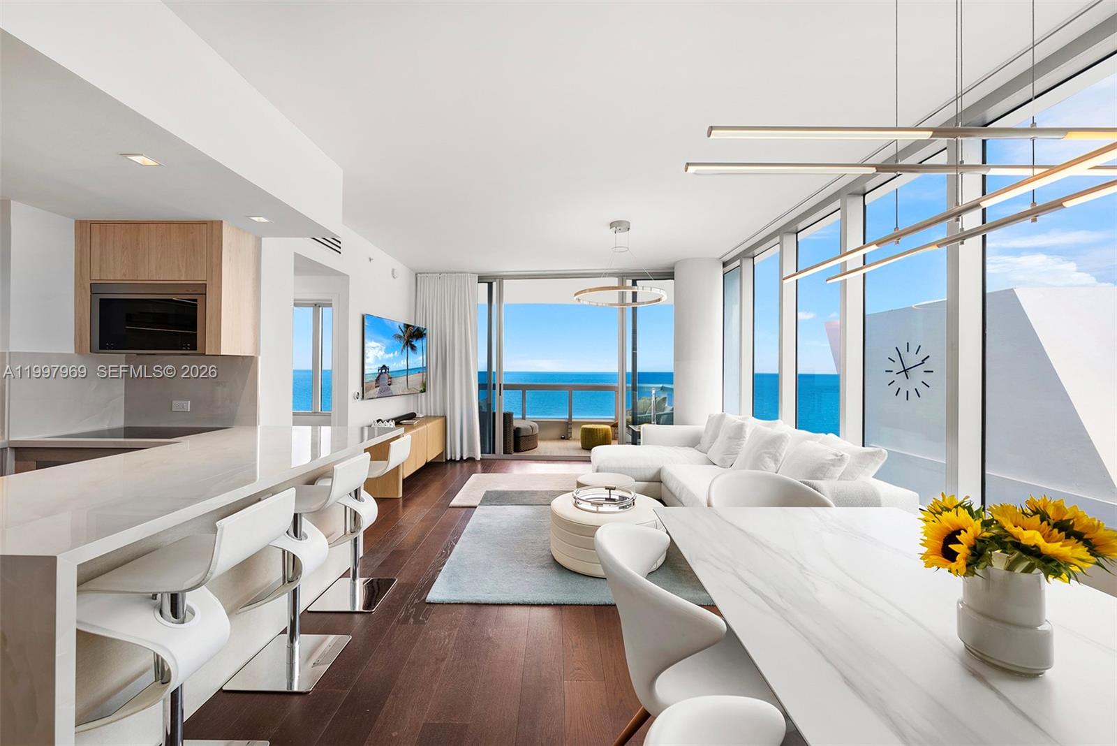 6899 Collins Avenue, Unit 1908 Miami Beach, FL 33141 - Photo 4 of 63 a living room with furniture and a fireplace