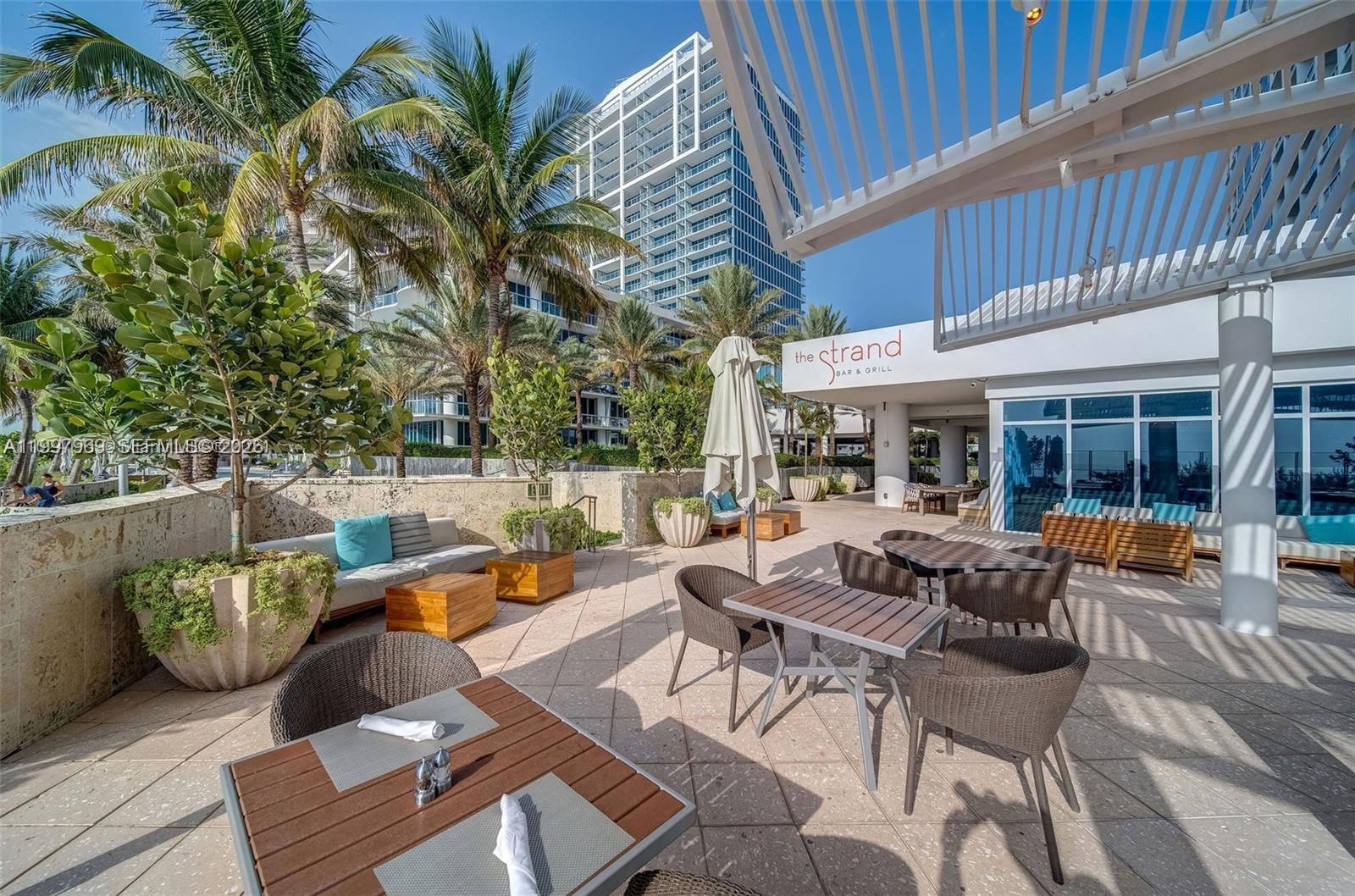 6899 Collins Avenue, Unit 1908 Miami Beach, FL 33141 - Photo 41 of 63 a outdoor space with patio furniture and potted plants