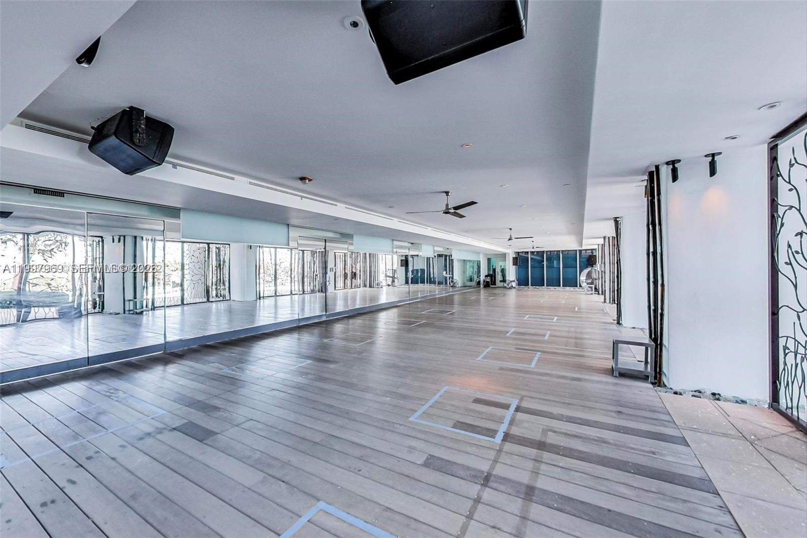 6899 Collins Avenue, Unit 1908 Miami Beach, FL 33141 - Photo 42 of 63 a view of empty room with wooden floor and floors