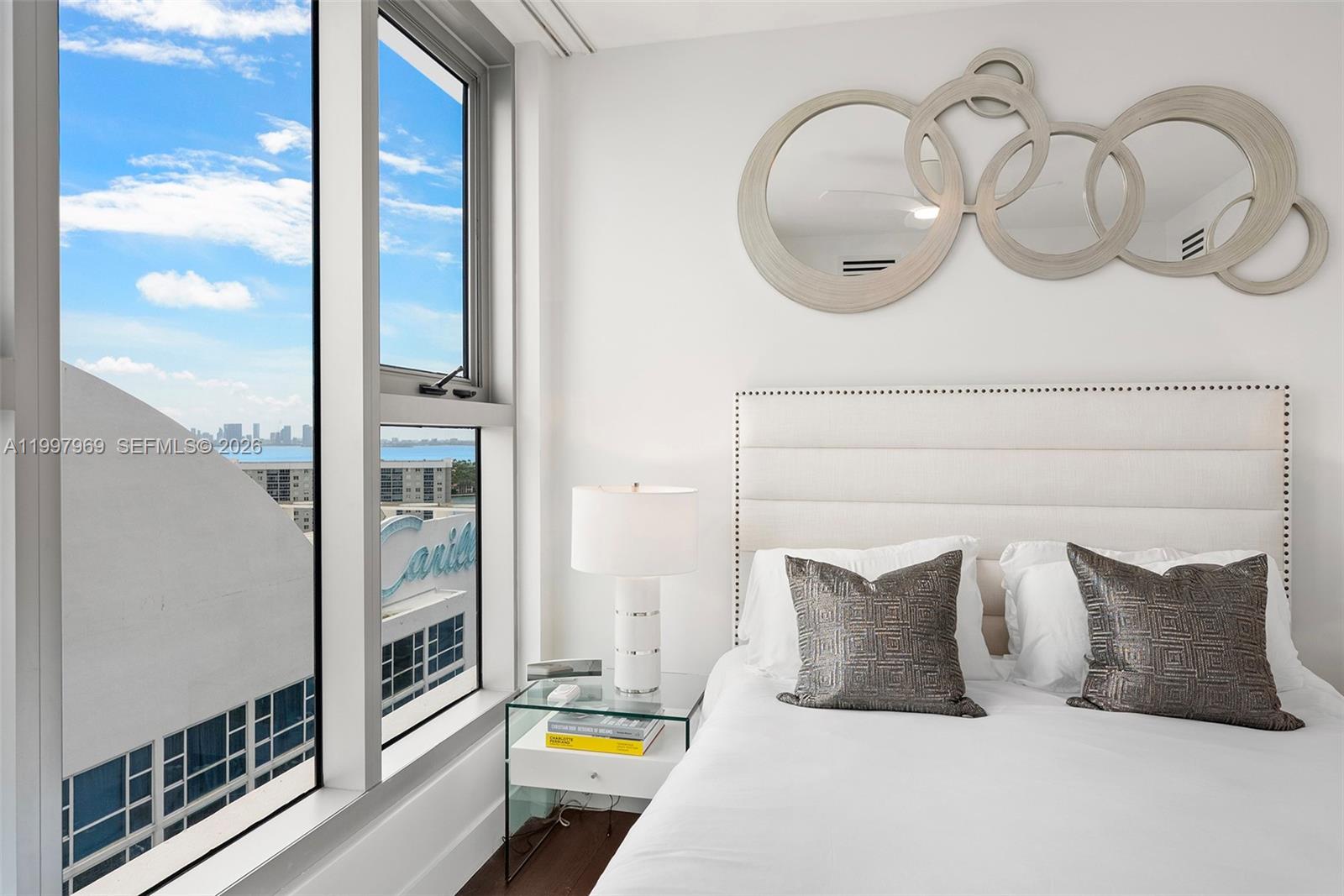 6899 Collins Avenue, Unit 1908 Miami Beach, FL 33141 - Photo 43 of 63 a large bed sitting in a bathroom next to a mirror