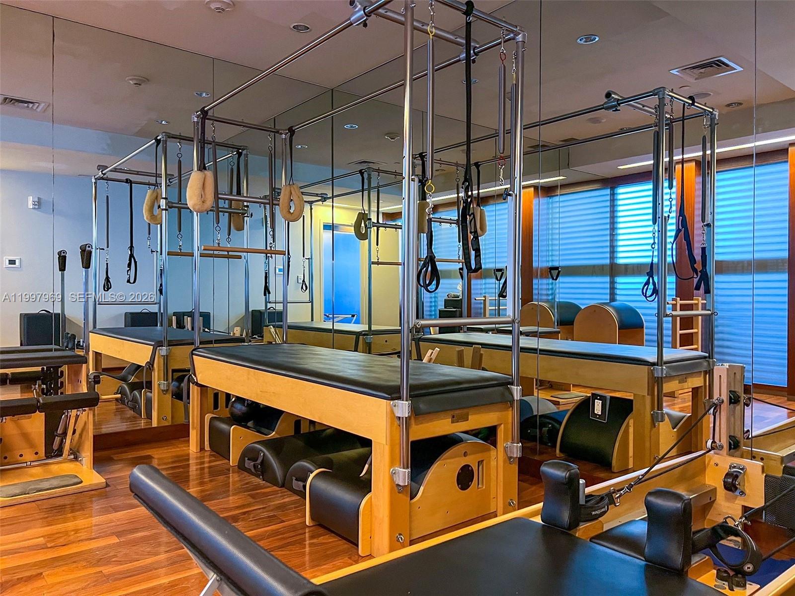 6899 Collins Avenue, Unit 1908 Miami Beach, FL 33141 - Photo 46 of 63 a room with gym equipment and a large window