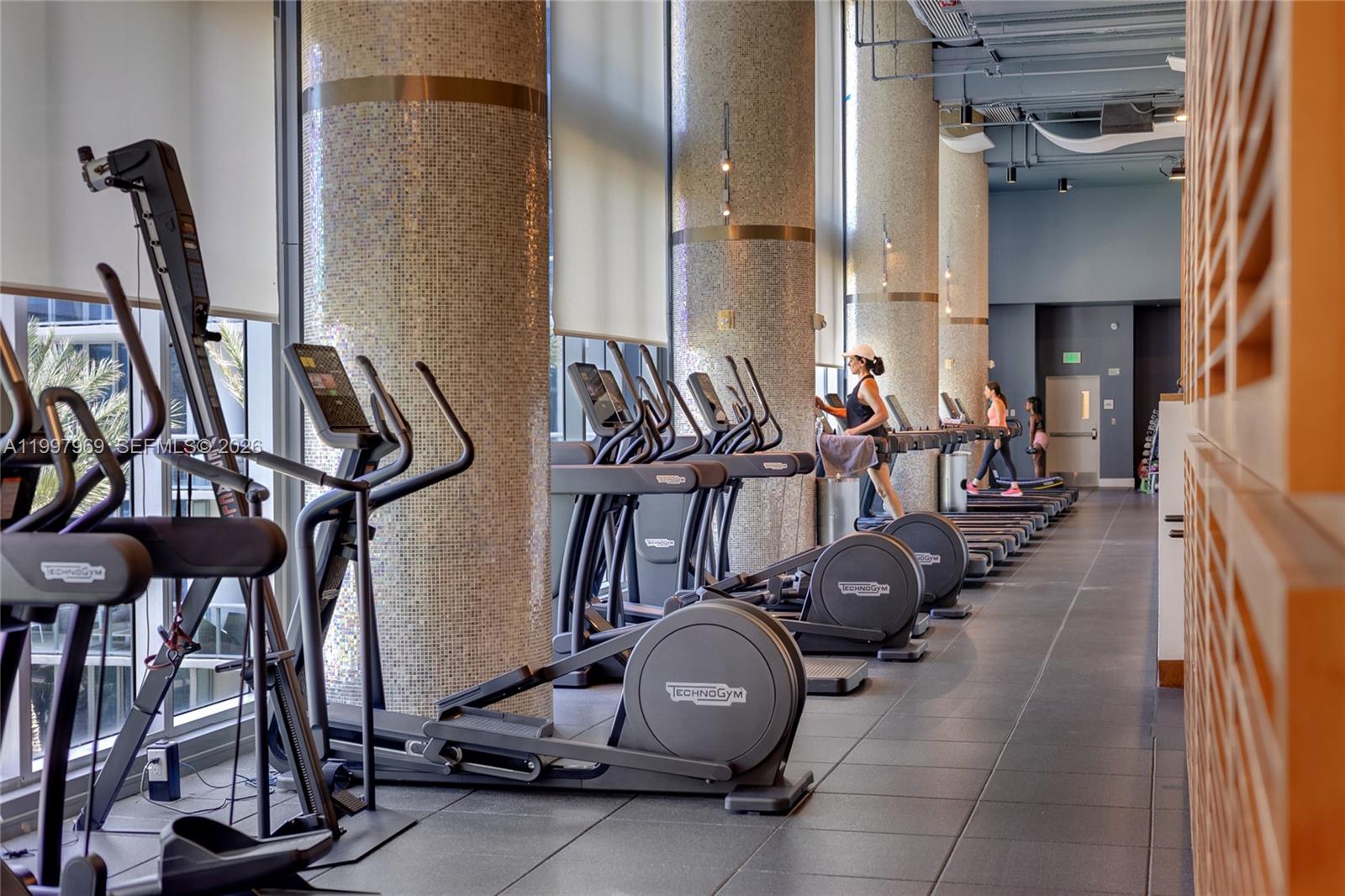 6899 Collins Avenue, Unit 1908 Miami Beach, FL 33141 - Photo 48 of 63 a view of a room with gym equipment