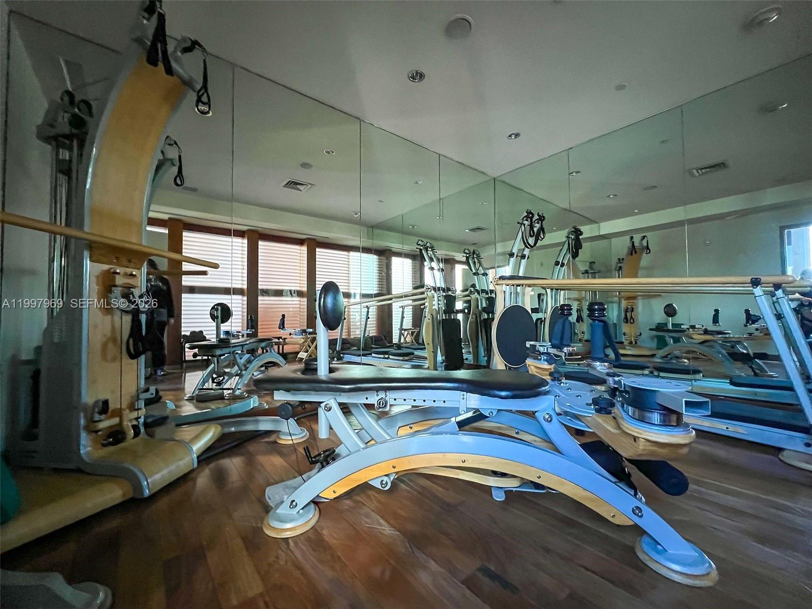 6899 Collins Avenue, Unit 1908 Miami Beach, FL 33141 - Photo 53 of 63 a view of a room with gym equipment