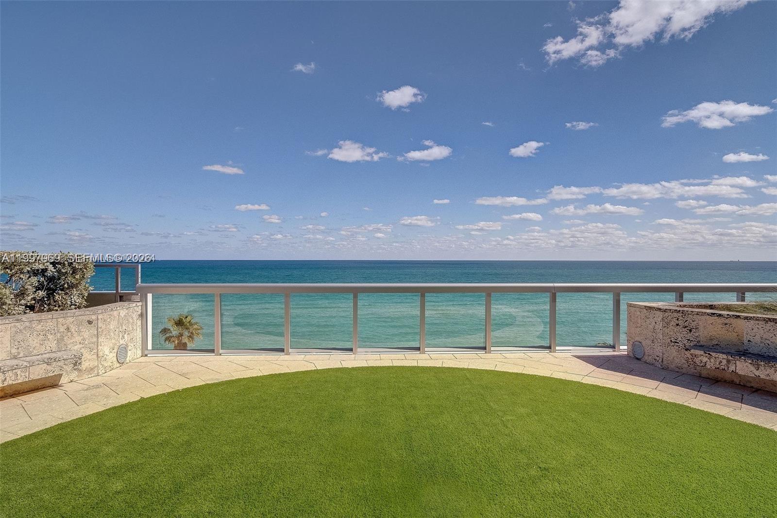 6899 Collins Avenue, Unit 1908 Miami Beach, FL 33141 - Photo 58 of 63 a front view of a house with a garden and yard