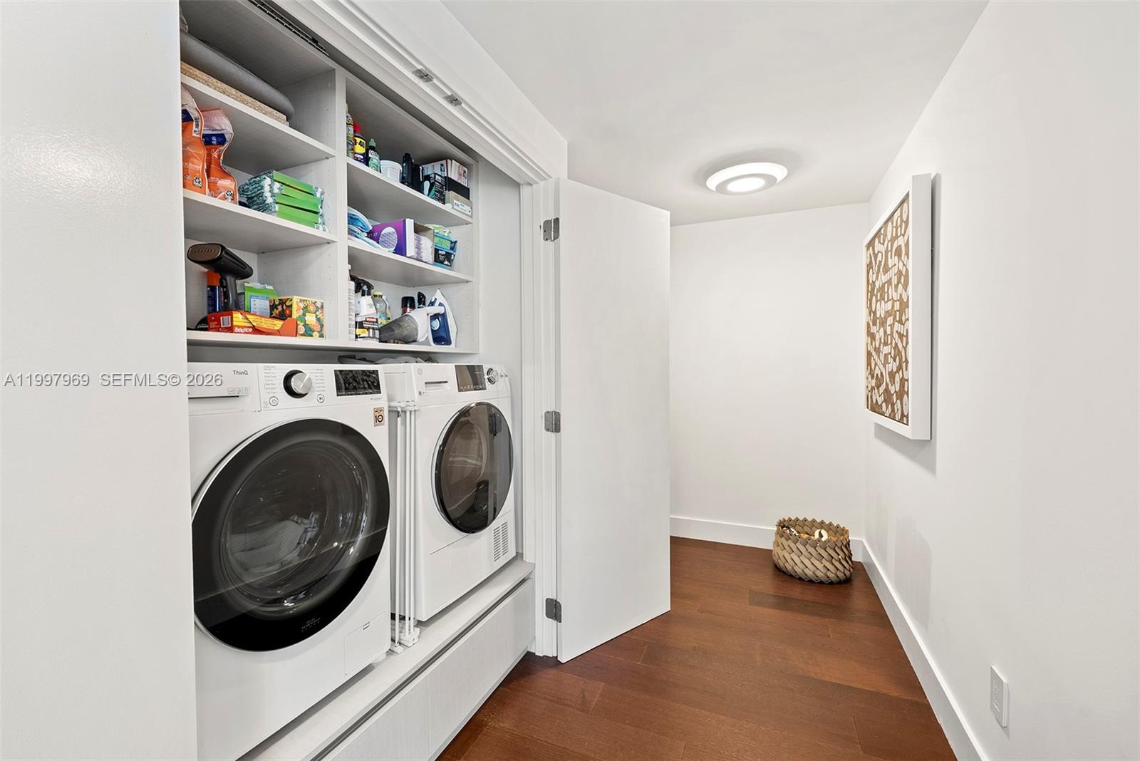 6899 Collins Avenue, Unit 1908 Miami Beach, FL 33141 - Photo 8 of 63 a utility room with dryer and washer