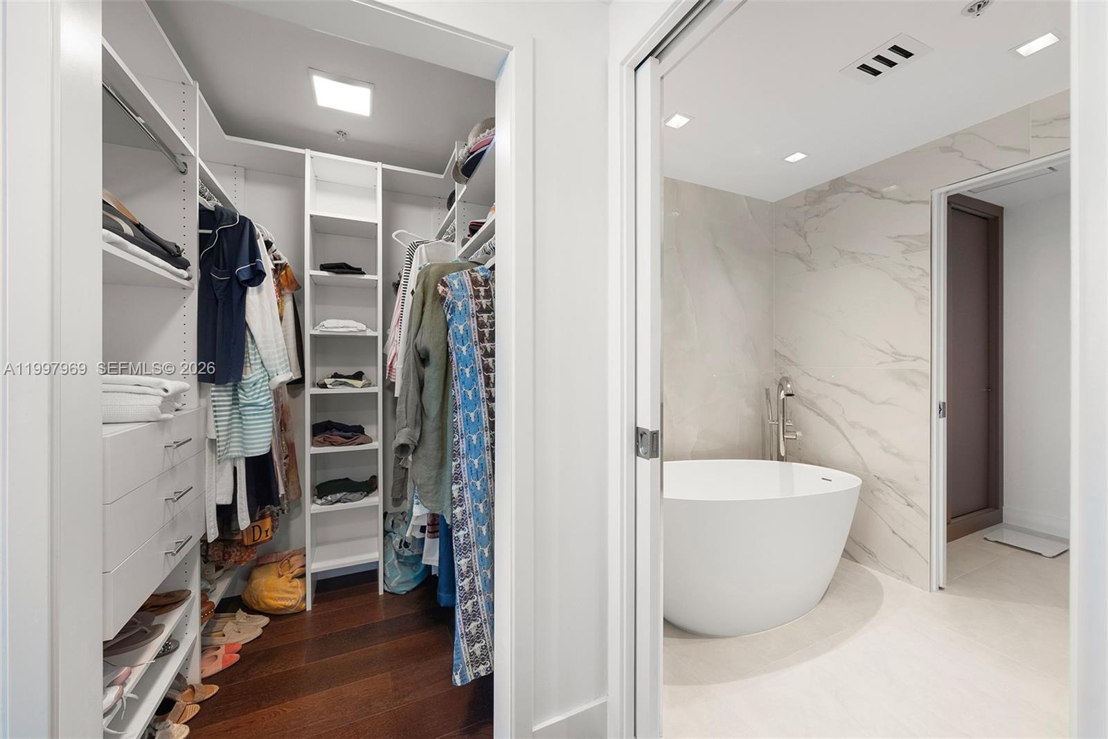 6899 Collins Avenue, Unit 1908 Miami Beach, FL 33141 - Photo 9 of 63 a view of walk in closet with clothes and shoes
