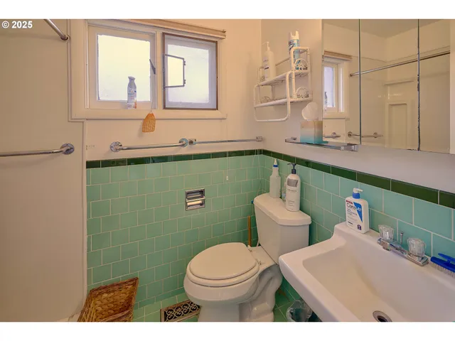 a bathroom with a sink toilet and mirror