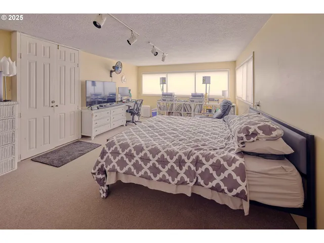 a bedroom with a large bed and a window