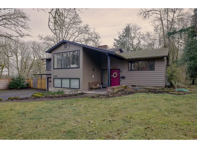 a backyard of a house with table and chairs
