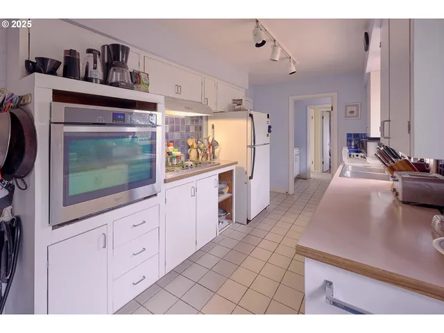 a open kitchen with cabinets a sink and wooden floor