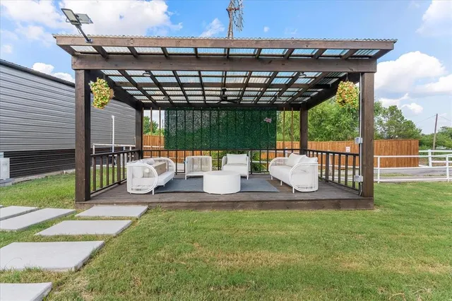 a patio view with a seating space and a garden