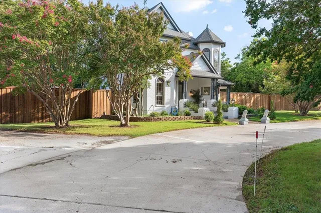 a view of a house with basketball court and palm trees