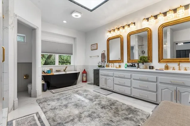 a large bathroom with a large mirror vanity and shower