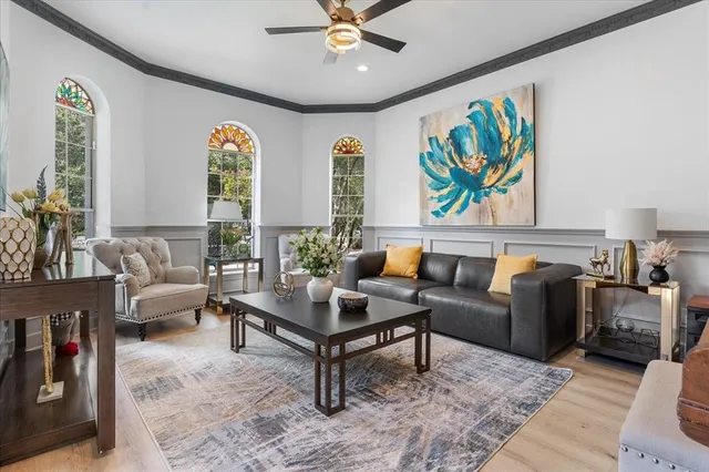 a living room with furniture and paintings on the wall