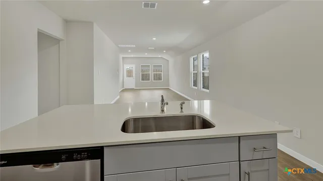 a kitchen with a sink and a refrigerator