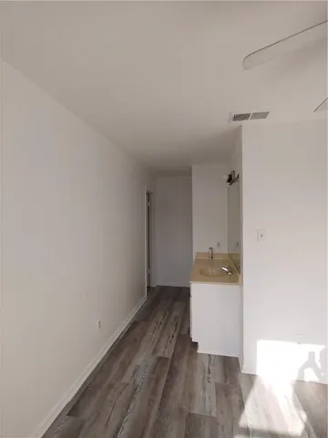 a room with a wooden floor and a sink