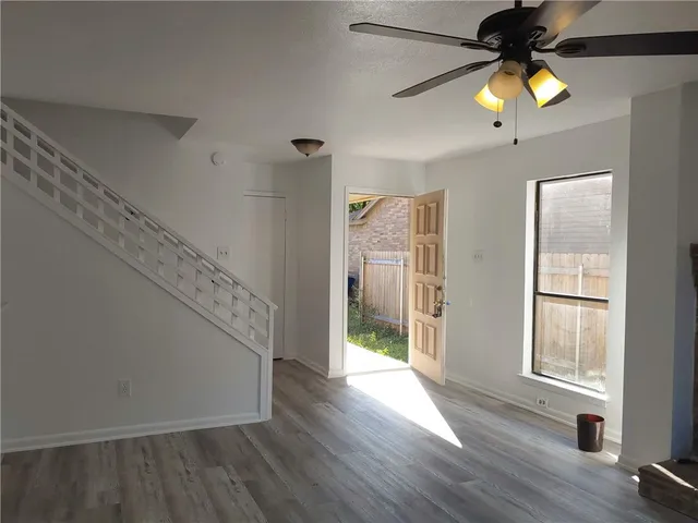 a view of an entryway with wooden floor and window