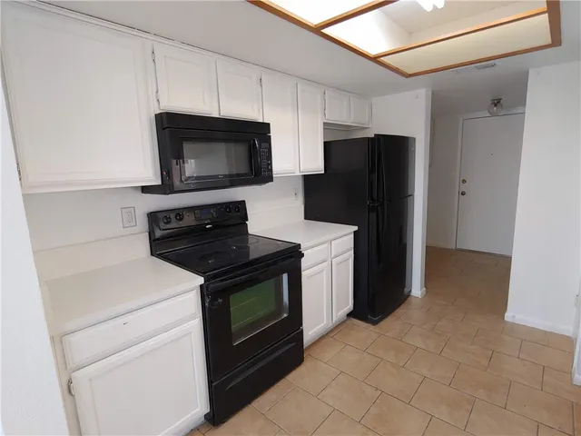 a kitchen with stainless steel appliances granite countertop a refrigerator stove and microwave